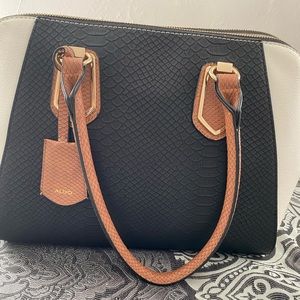 White and black faux snake skin handheld purse with attachable straps from Aldo